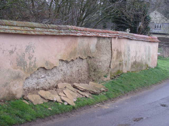 Witchert wall, in Nether Winchendon, typically needing regular maintenance to retain its weatherproof plastering and tiled cover.